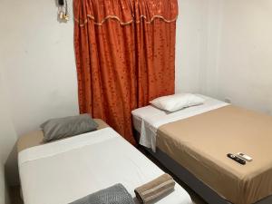 En eller flere senge i et værelse på Hostal Bellettini