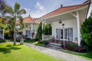 a home with a porch and a yard at Sanghyang Bay Villas in Nusa Lembongan