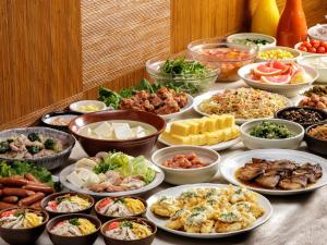 a table topped with lots of different types of food at Nishitetsu Inn Shinjuku in Tokyo