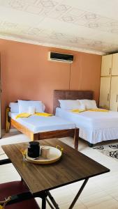 a room with two beds and a table with a plate on it at Starlight bed and breakfast in Katima Mulilo