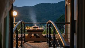 a grill with food on a table on a balcony at Gapyeong Rubino Pension in Gapyeong