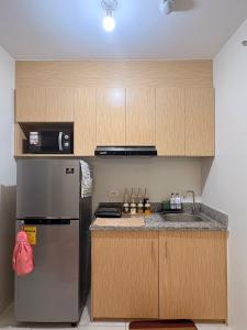 a kitchen with a stainless steel refrigerator and a sink at 2BR Condo Near IT Park and Malls in Mandaue City +28 photos