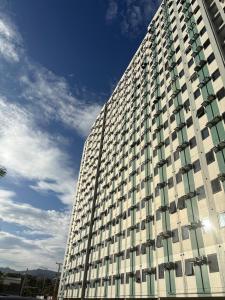 a tall building with windows on the side of it at 2BR Condo Near IT Park and Malls in Mandaue City