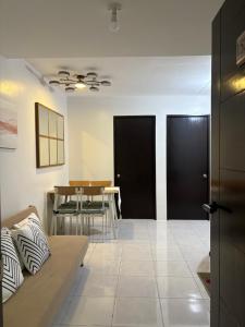 a living room with a table and black doors at 2BR Condo Near IT Park and Malls in Mandaue City