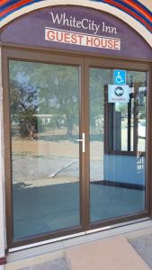 a front door of a white city inn guest house at White City Inn in Gaborone