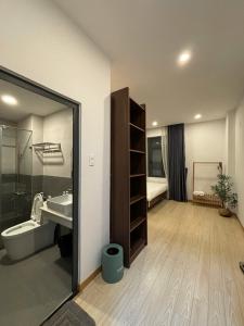 a bathroom with a sink and a toilet and a shower at Quỳnh An Home in Da Lat