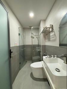 a bathroom with a toilet and a shower and a sink at Quỳnh An Home in Da Lat +33 photos