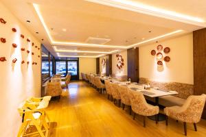 a dining room with a long table and chairs at The Naori by Alaya Stays in Udaipur