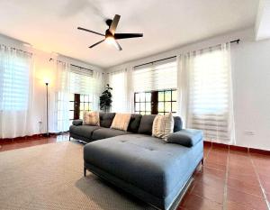 a living room with a couch and a ceiling fan at Daria Beachfront community steps 2 pool- Generator in Brenas