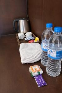 two bottles of water and towels on a table at Landmark Inn in Lanka