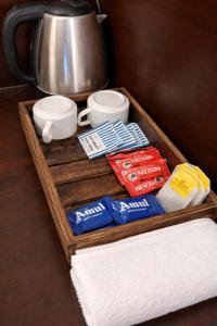 a wooden tray with towels and a coffee pot at Landmark Inn in Lanka