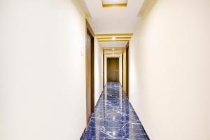 a corridor of a building with blue tiles on the walls at Hotel O Shalimar in Mumbai