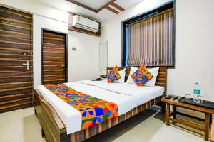a bedroom with a large bed and a desk at Hotel O Shalimar in Mumbai +20 photos
