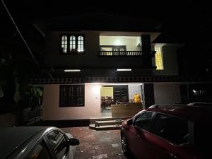 a car parked in front of a house at night at Bluebell Homes A - 3 BHK Near to Calicut in Beypore