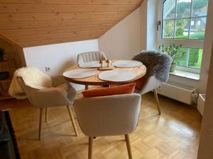 a dining room with a wooden table and chairs at Mein Sauerland in Medebach