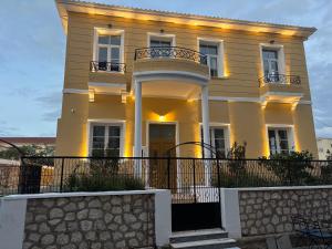 a white house with a balcony on top of it at Maissance in Preveza