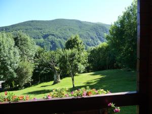 a window view of a green field with a tree at Maldagorri in Ezkurra