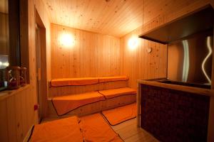 a sauna with three shelves in a wooden room at カプセルホテルグロリア in Beppu