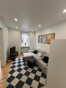 un soggiorno con un divano e una TV di Central City Apartment Mozart a Kaiserslautern