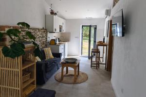 a living room with a blue couch and a table at Las Huertas del Abrilongo in La Codosera