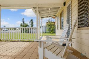 a porch with a bench on a house at Packem Inn in Lancelin