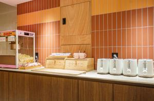 a kitchen with a counter with white cups on it at 호텔인카페 파주금촌점 in P'aju +125 photos