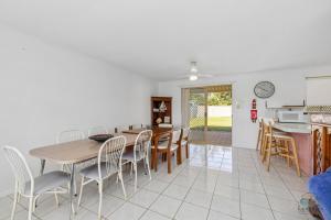 a kitchen and dining room with a table and chairs at Packem Inn in Lancelin +8 photos