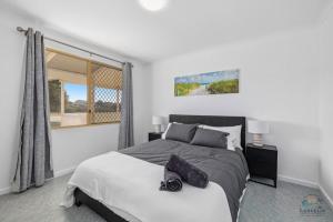 a bedroom with a large bed and a window at Packem Inn in Lancelin