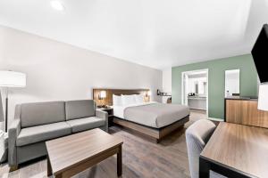 a hotel room with a bed and a couch at Quality Inn & Suites Port Lavaca near Lighthouse Beach in Port Lavaca +92 photos