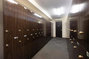 a walk in closet with wood panels and a black door at カプセルホテルグロリア in Beppu +24 photos