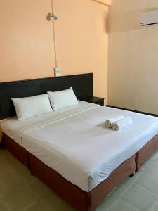 ein großes Bett mit zwei Handtüchern darauf in der Unterkunft Centerpoint Hotel in Trang