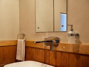 a bathroom with a sink and a mirror at Deoja Forest Stay in Darjeeling
