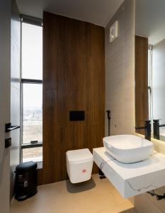a bathroom with a white toilet and a sink at FTM Residence in Abuja