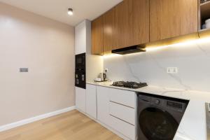 a kitchen with a washer and dryer in it at FTM Residence in Abuja +9 photos