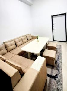 a living room with a couch and a table at City Center Apartment "Afsona mall" in Irvadan