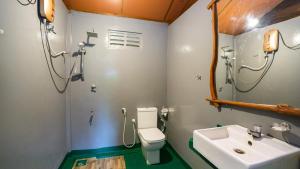 a bathroom with a toilet and a sink at Chena Huts Eco Resort in Sigiriya