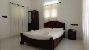 En eller flere senge i et værelse på Tamarind Heritage Holiday Home