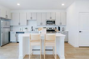 eine Küche mit weißen Schränken und einer weißen Arbeitsplatte in der Unterkunft A plus Location WorkerFriendly KINGbed Pool Gym Modern in Sherman + 10 Fotos