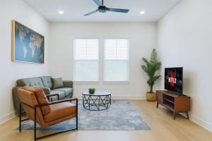 a living room with a couch and a tv at Modern A plus Location KINGbed pool gym in Sherman