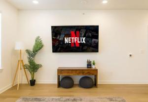 a living room with a table with a netflix sign on the wall at Relaxing 1BR escape worker friendly A plus Location in Sherman