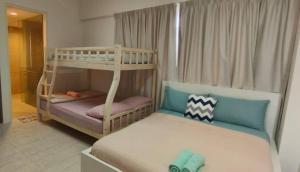 a childs bedroom with a bunk bed and a bunk bedouble at By the sea Beach Front, Seaview And Pool side in Batu Ferringhi