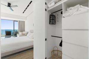 a bedroom with a bed and a view of the ocean at Encantame Soleil New Resort 3rd Floor Studio in Playa Encanto