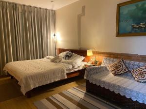a bedroom with two beds and a window at L'e'tage House in Hanoi