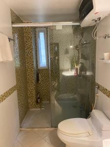 a bathroom with a shower and a toilet and a sink at L'e'tage House in Hanoi +26 photos