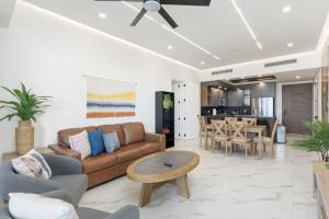 a living room with a couch and a table at Encantame Soleil 2nd floor 2Br Sleeps8 in Playa Encanto