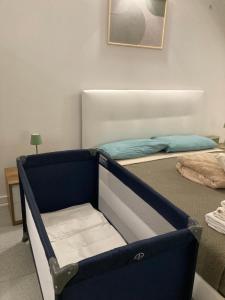 a bedroom with a bed with a blue frame at F&F Room in Sassari