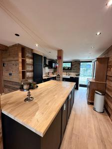 a kitchen with a wooden counter top in a room at Domaine de Hurlevent - Gite 10 personnes - Le Refuge in Aywaille