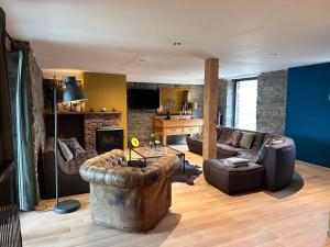 a living room with a couch and a chair at Domaine de Hurlevent - Gite 10 personnes - Le Refuge in Aywaille