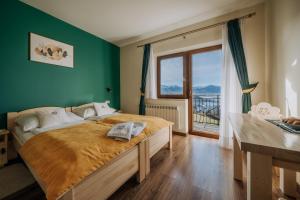 a bedroom with a large bed and a window at Willa Sulejowka in Poronin