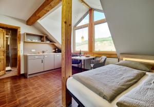 a bedroom with a bed and a table in a room at Weingut Schumann in Lieser
